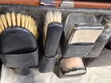 a close up of a suitcase with brushes in it