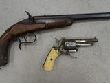 two guns that are on the floor next to each other