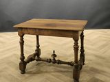 an old wooden table sitting on top of a hard wood floor