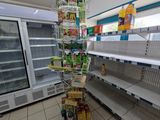 many shelves in the store that have food on them