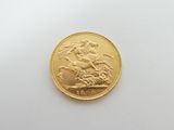 an image of a gold sovereign coin on a white surface