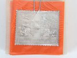 an orange bag with a silver picture on it