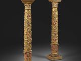 une paire de colonnes sculptées et dorées reposant sur des socles