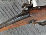 a close up of a rifle that is on display