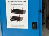 a blue box with a sign on it that says smart broder heating plate