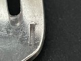 a close up of a metal object on a black surface
