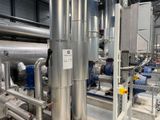 pipes and valves in a large industrial building with a lot of pipes