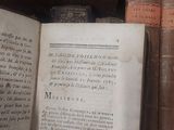 many old books on a shelf in a room
