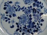 a blue and white plate with blue flowers on it
