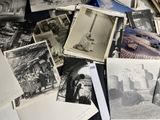 a pile of old black and white photos on a table