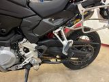 a black motorcycle parked in a showroom next to other motorcycles