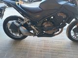 a black motorcycle parked in a parking lot