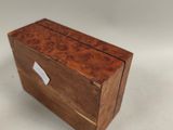 an image of a small wooden box on a white surface