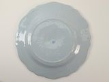 a blue plate on a white table with a white background