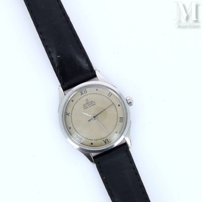 a close up of a watch on a black strap on a white surface