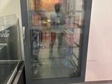 a refrigerated refrigerator in the corner of a kitchen