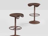 a pair of stools made of metal and wood