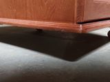 a wooden dresser with a drawer on top of it