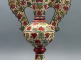 a vase with a floral design on it sitting on a table