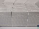 four boxes of white boxes with writing on them sitting on a table