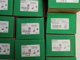 several green boxes stacked on top of each other in a room