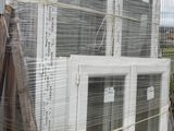 a pile of windows sitting on top of a wooden pallet