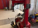 a red machine that is sitting on a pallet in a room