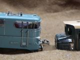 two toy trains sitting side by side on the ground