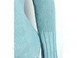 a close up of a woman wearing a blue sweater and jeans