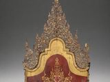 an image of a gold and red headboard on a gray background