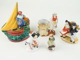 five figurines of people on a white surface
