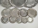 a lot of silver plates on a white table