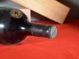 a bottle of wine sitting on a red table cloth