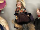 three dolls that are sitting next to each other on a shelf