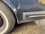 a close up of a car ' s door handle and tire
