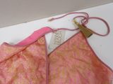 a pink bra top with a pink ribbon on it