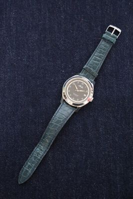 an image of a watch sitting on top of a blue cloth