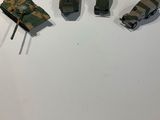 four toy cars that are sitting on a white surface