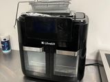 an image of a black and silver coffee maker on a counter