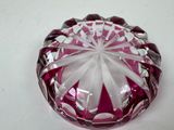 a pink glass bowl with a white bow on it
