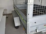 a truck with a cage on top of it in a room