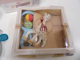 a box with a pair of scissors and a toy giraffe in it