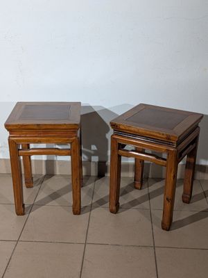 two wooden tables sitting next to each other on a tiled floor