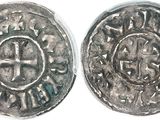 a close up of two silver coins on a white surface