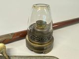 a silver tray with a spoon and a lamp on it