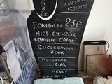 a blackboard sign on a table with a bunch of items on it