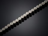 a close up of a row of silver coins on a black surface