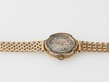 an image of a gold bracelet with a stone in the center