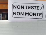 a sign that says non teste / non monte on a refrigerator