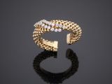 a gold ring with diamonds on a black surface